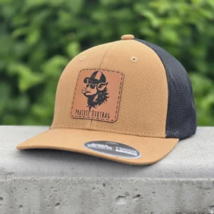 Prairie Dirtbags collection hats on AJM Tough Duck 8D017M trucker caps featuring The Young Buck, The Hog, The Smokin Raccoon, The Smokin Cow, and The Highland Cow designs.