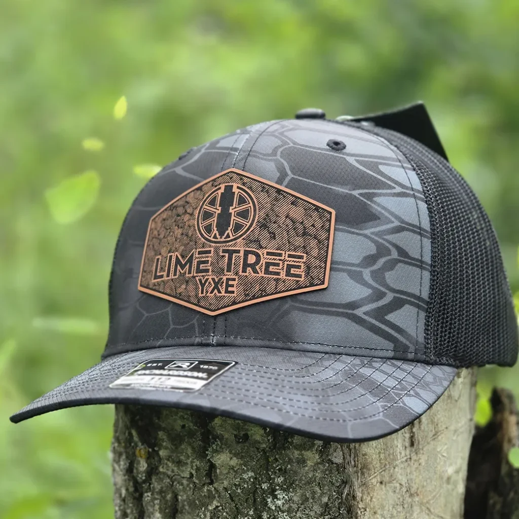 Premium custom trucker hat featuring a textured laser engraved leatherette patch with a crisp engraved logo and durable stitched finish.