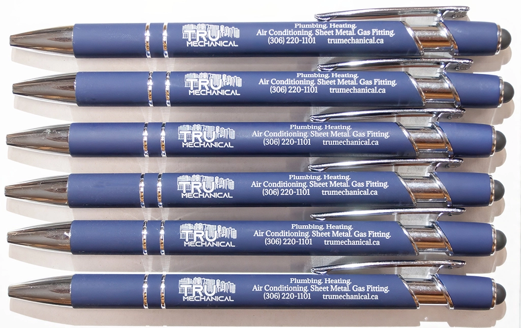 Six custom laser engraved blue promotional pens featuring the Tru Mechanical company logo, contact information, and chrome accents, created by Lime Tree YXE.