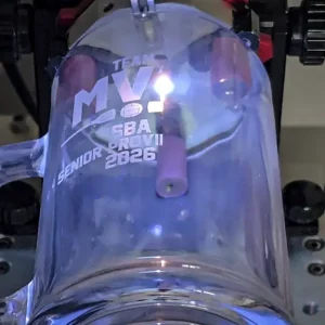 Laser engraving machine engraving a stainless steel tumbler in Saskatoon